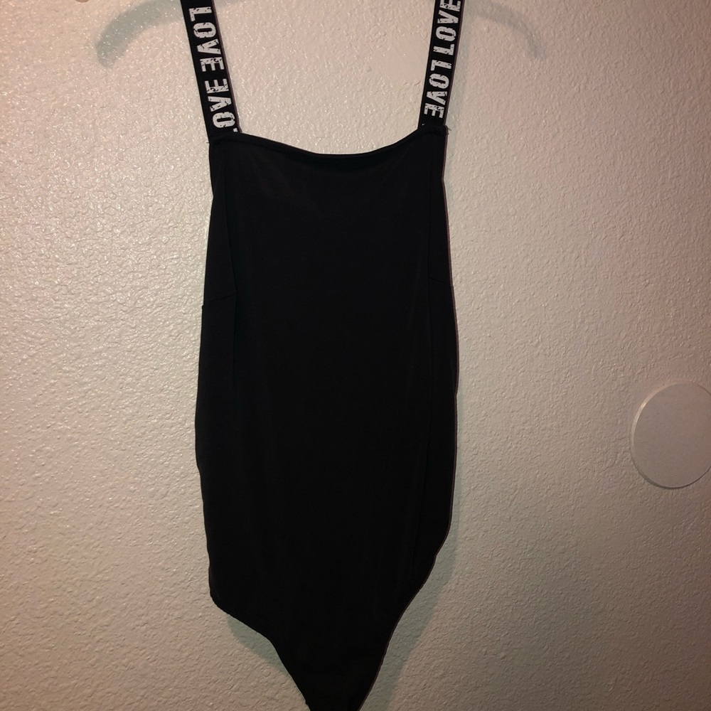 Black bodysuit says “Love” w back detailing & new